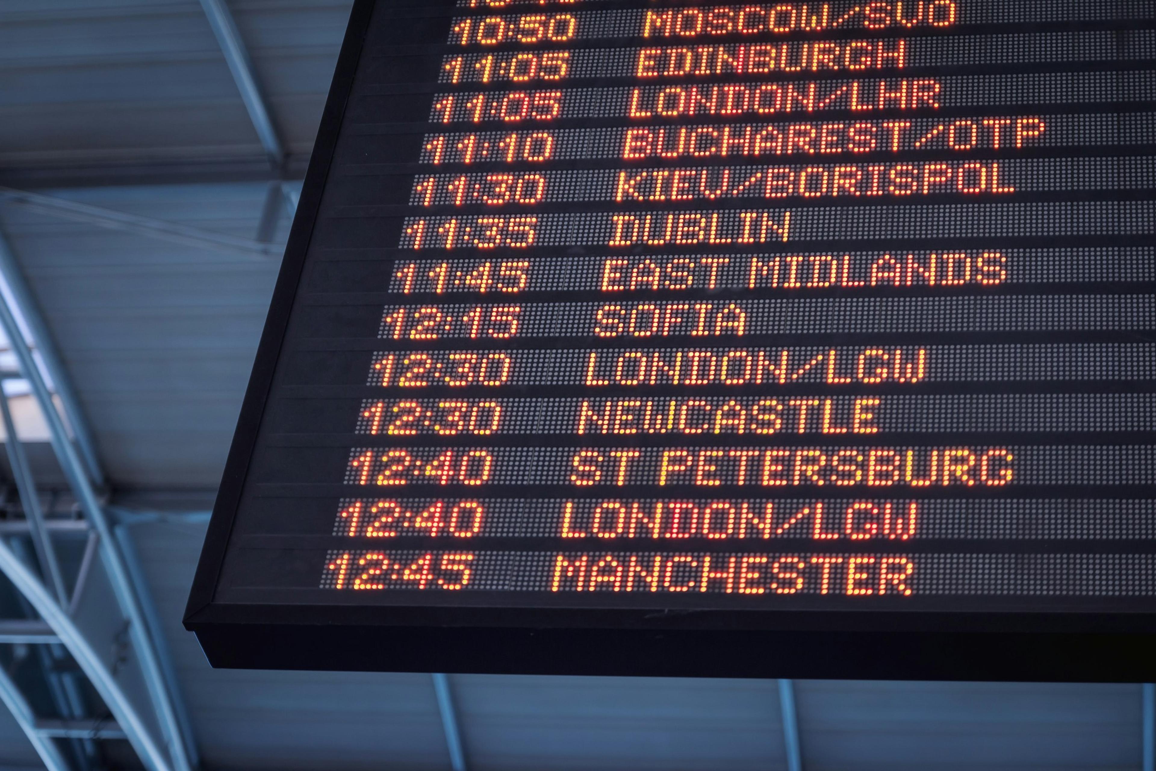 A departures board in an airport terminal
