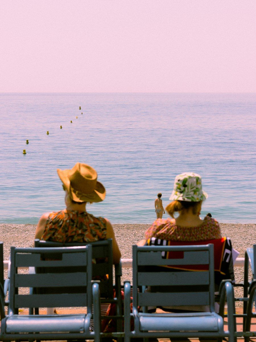 Two travellers sitting by the sea