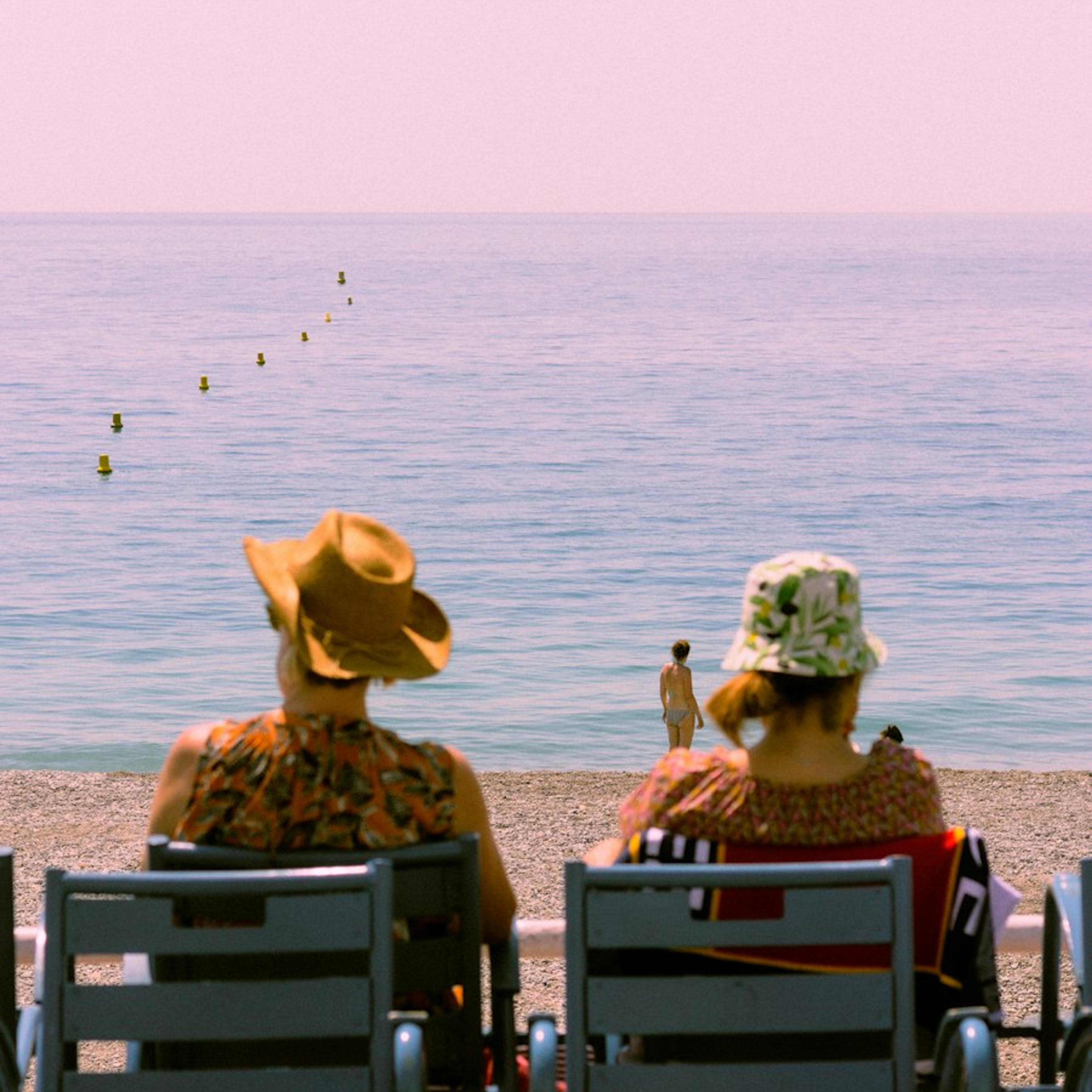 Two travellers sitting by the sea
