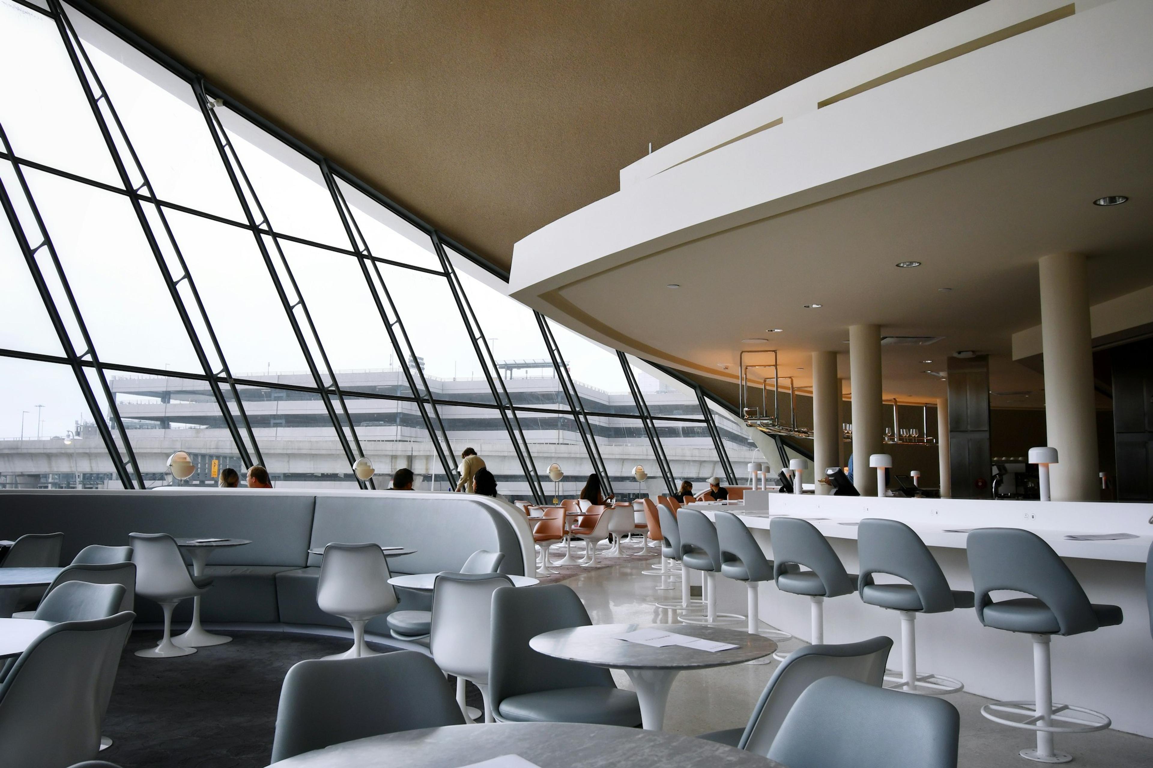 An airport lounge with large windows