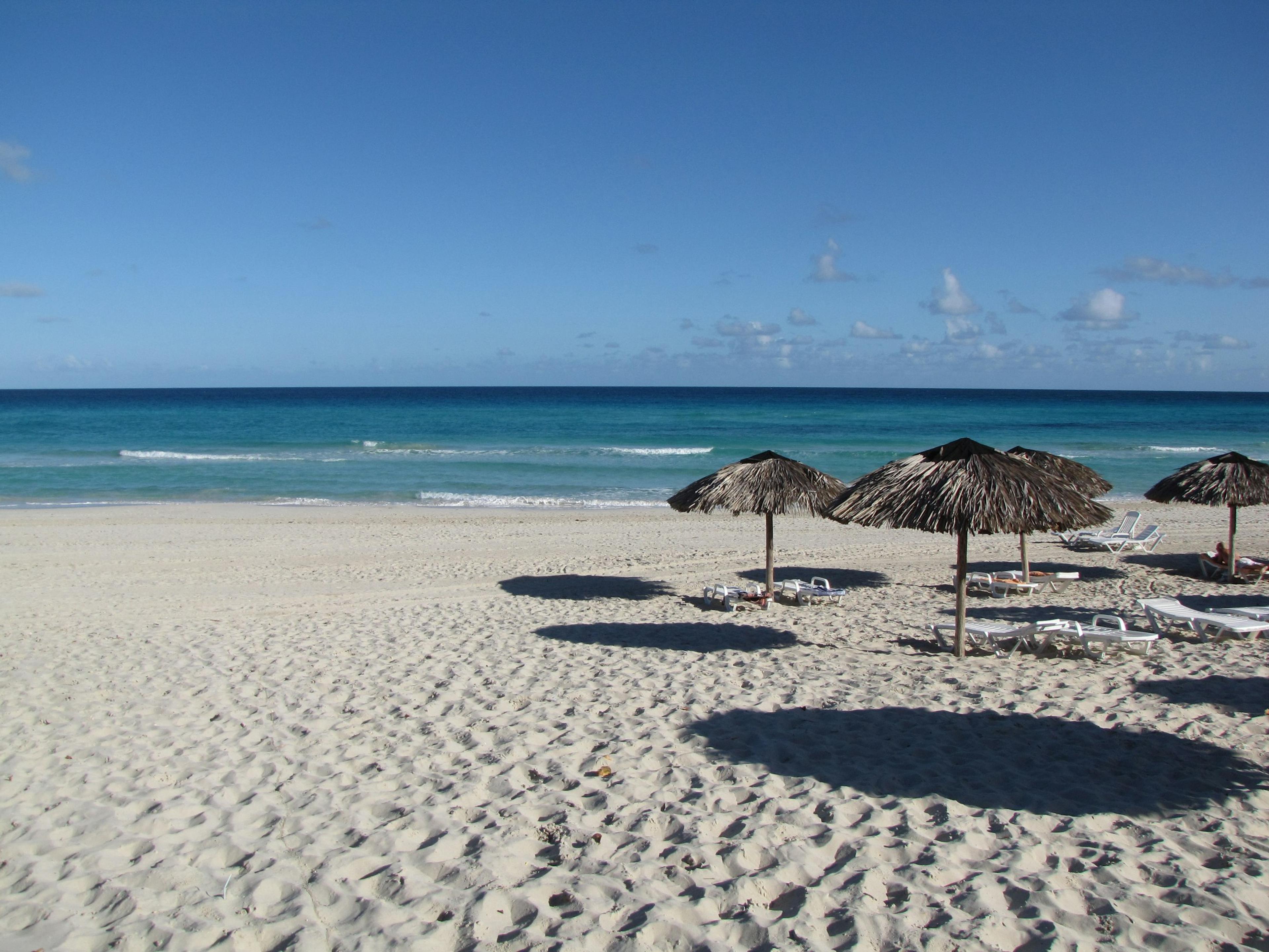 Straw umbrellas on a white sand beach