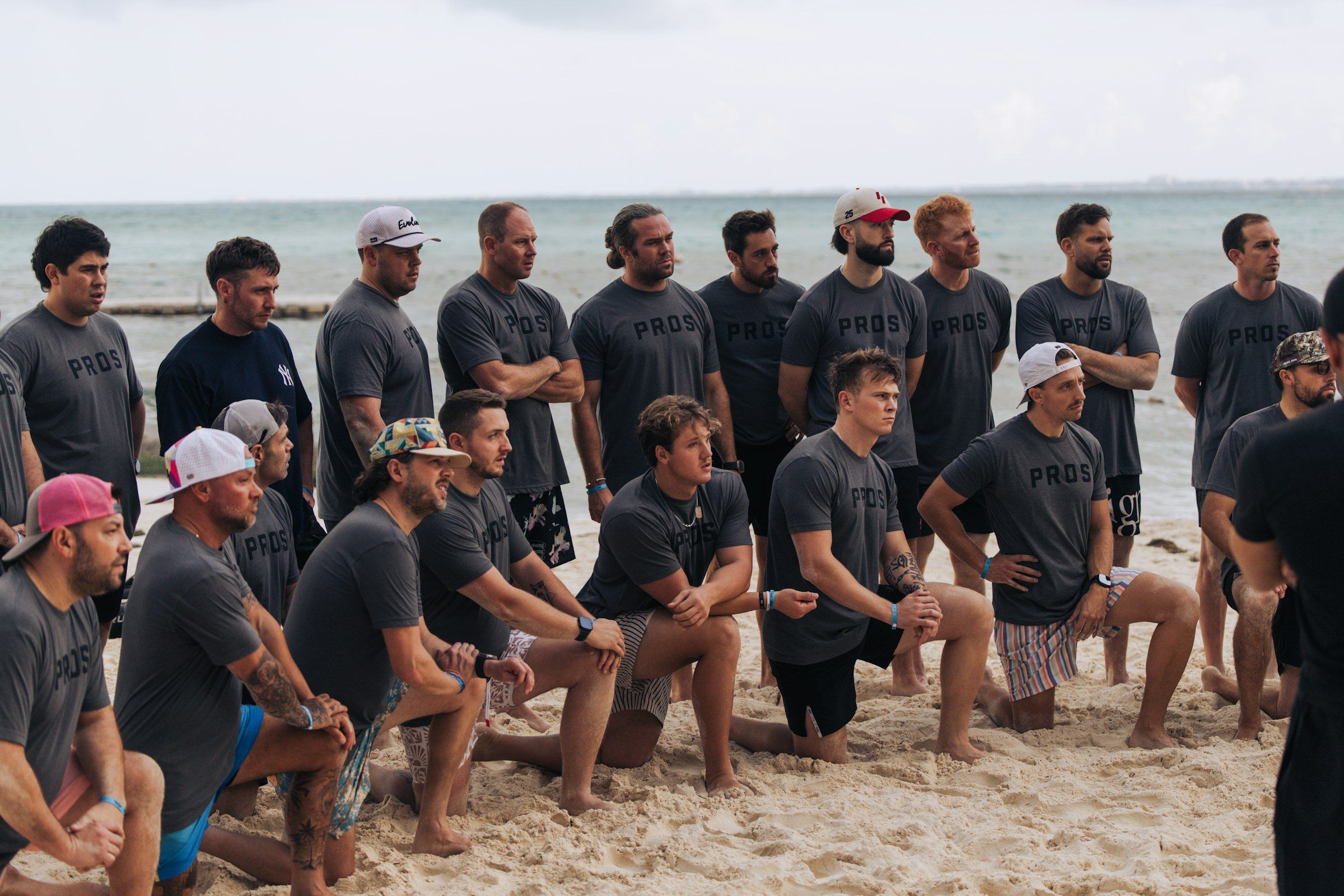 A group in matching shirts on a beach
