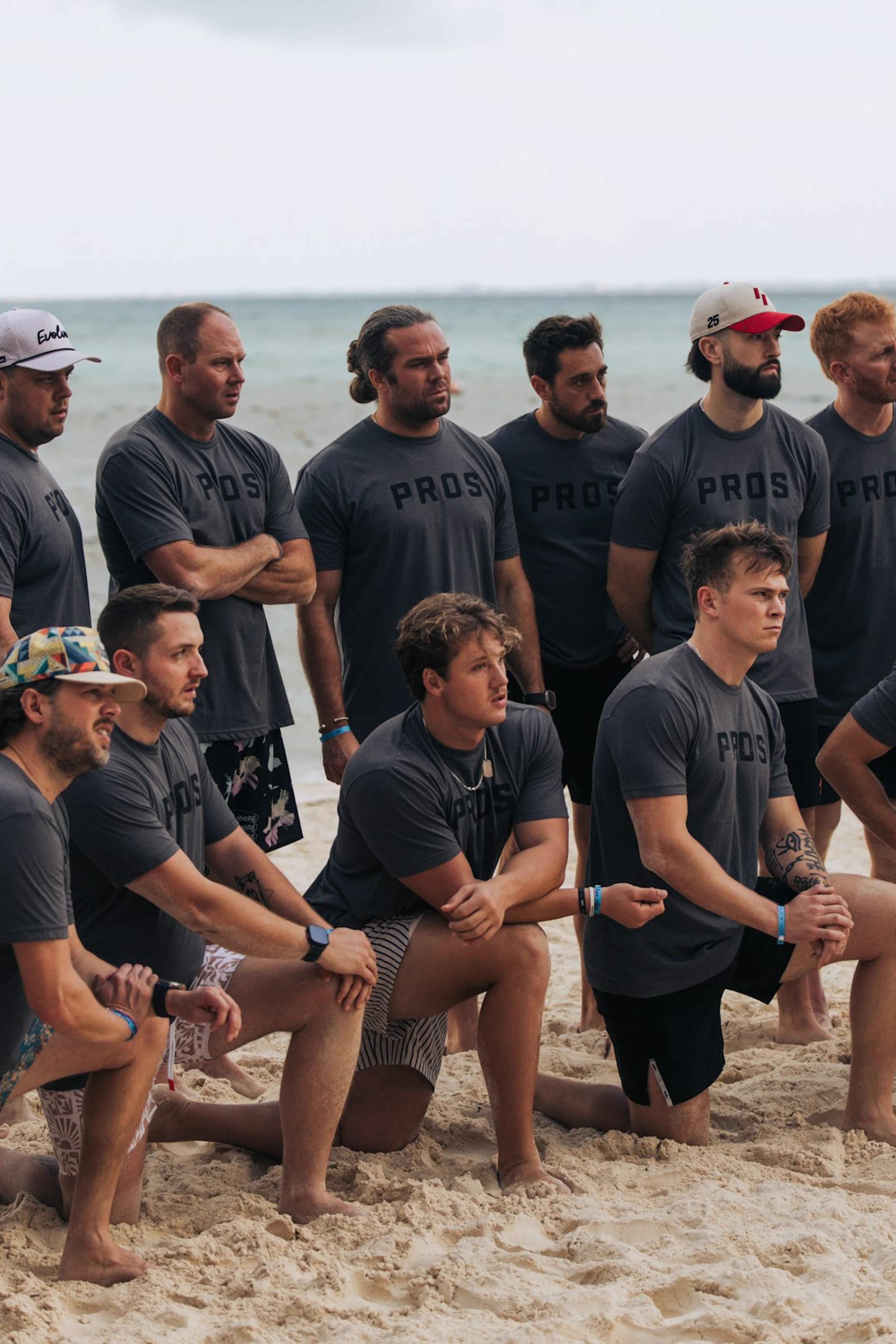 A group in matching shirts on a beach