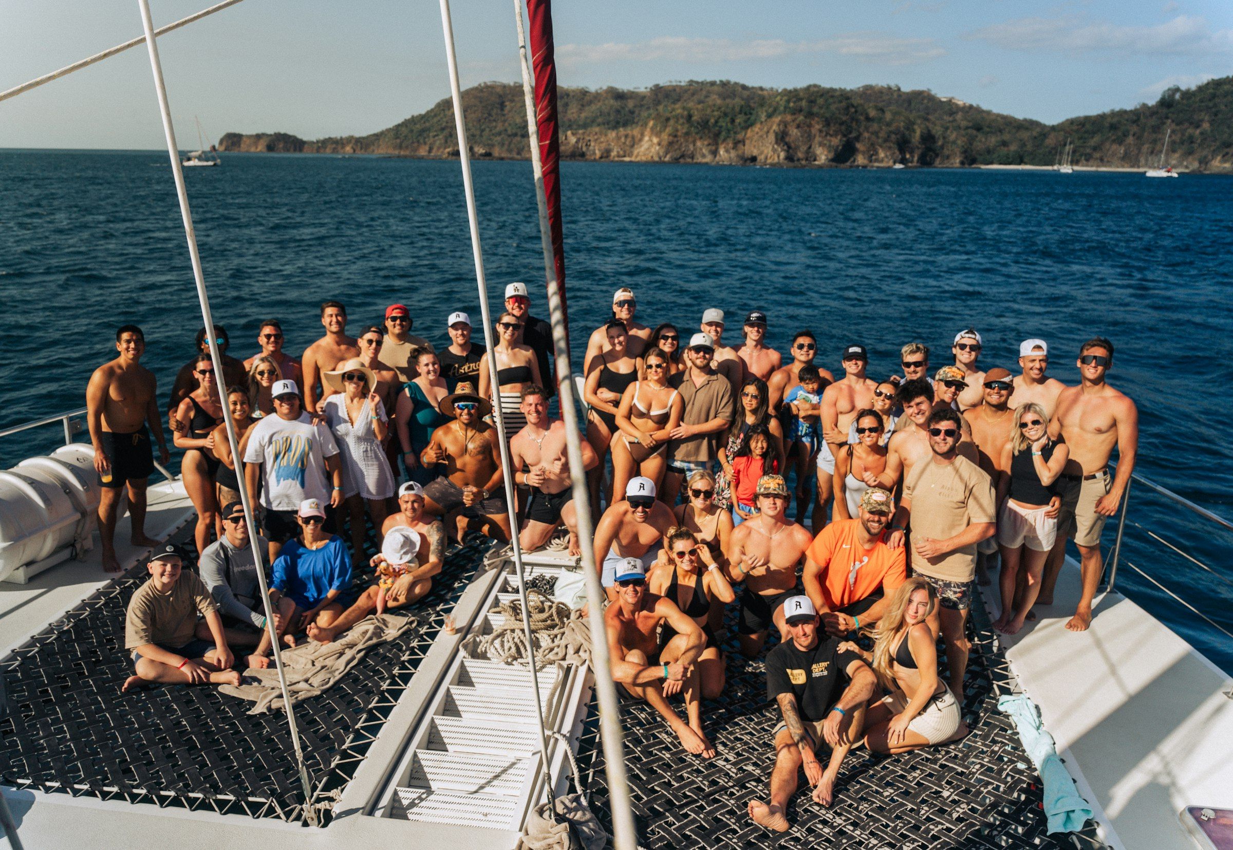 A large group of friends on a boat at sea