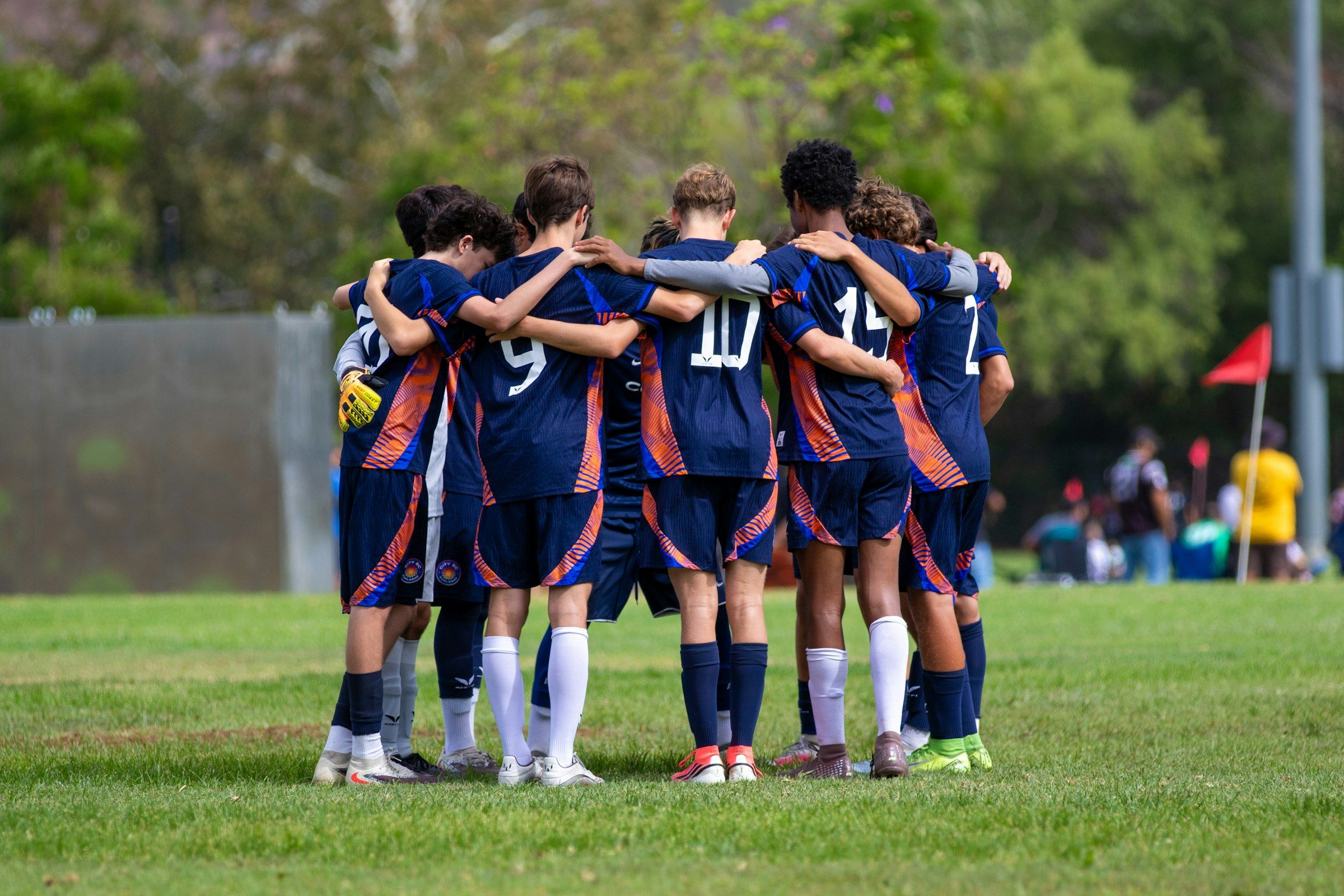 A soccer team huddled on the field