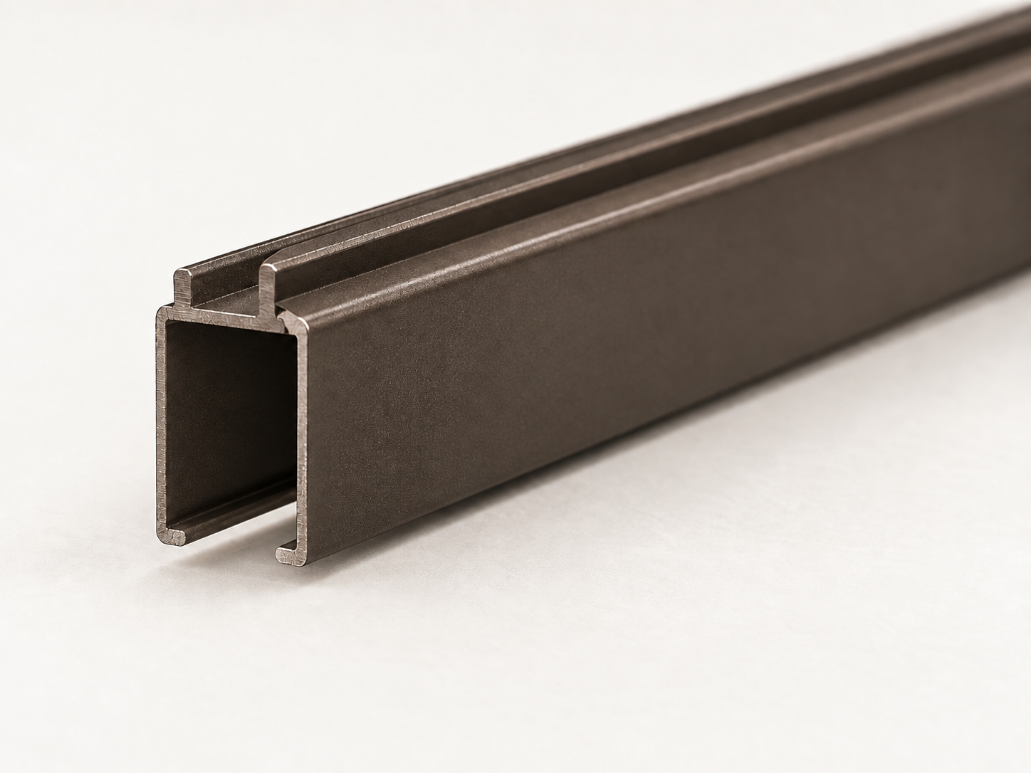 Bronze Architrac cut-track profile showing the rectangular channel and bottom running slot