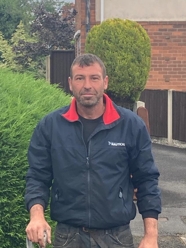 Paul ross standing infront of some bushes