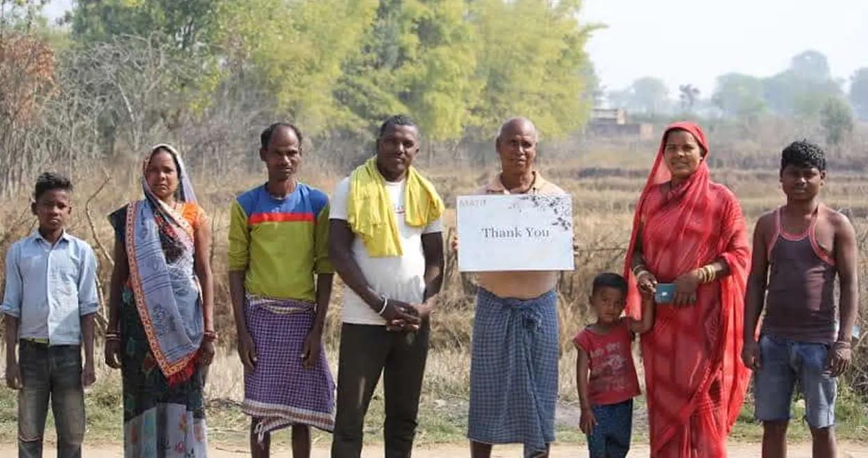 Farmers holding a thank you sign