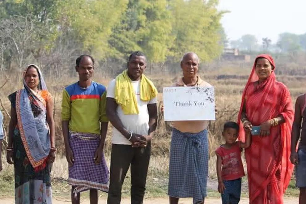 Farmers holding a thank you sign