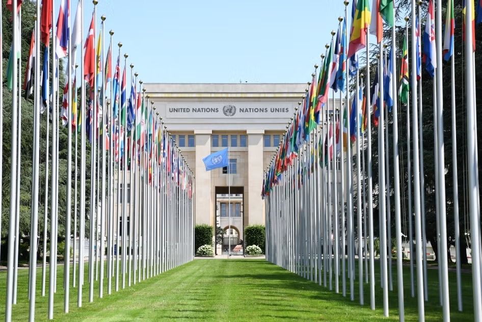 The Allée des Drapeaux, lined with the flags of UN Member States, leading to the Palais des Nations in Geneva