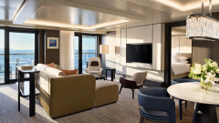 A residential suite interior with distinct sleeping, dining and sitting areas.
