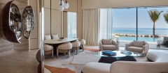 A villa lounge opening towards palms and the Red Sea.