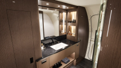A bathroom interior with a full-height vanity and enclosed shower.