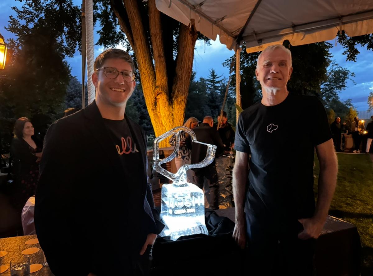 Tim Gill and Alex Capecelatro posing with award