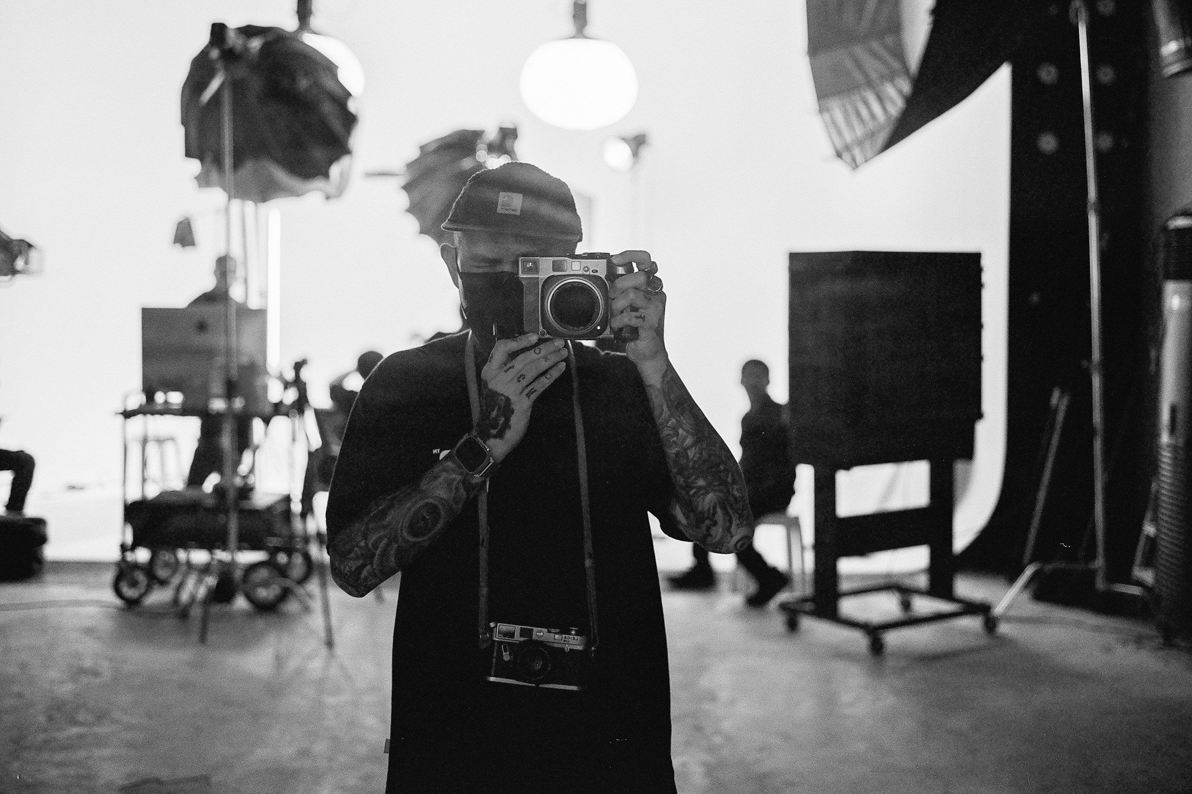 A person holding a camera in a room