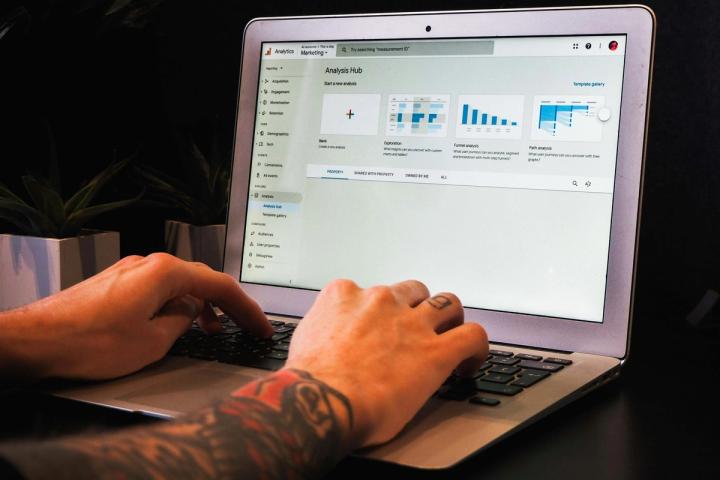 person using macbook pro on table