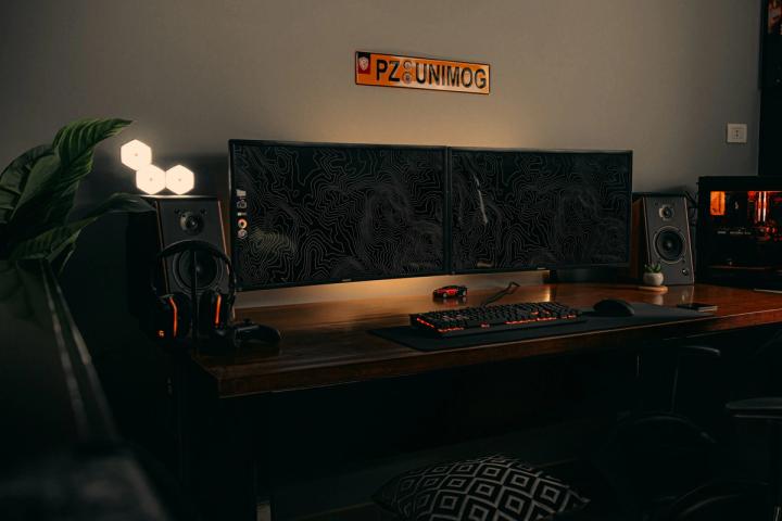 black flat screen computer monitor on brown wooden desk