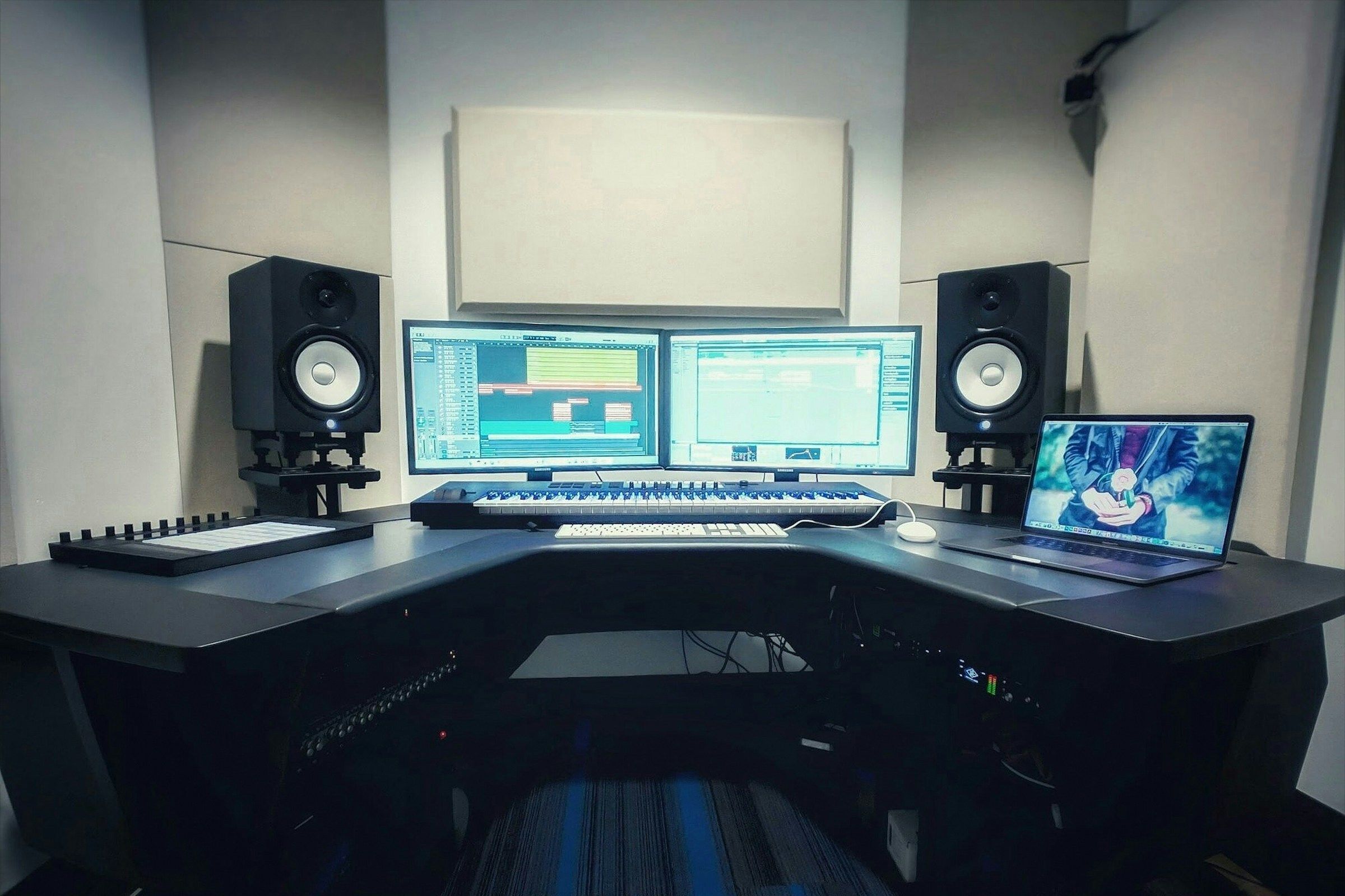 a computer desk with two monitors and a keyboard