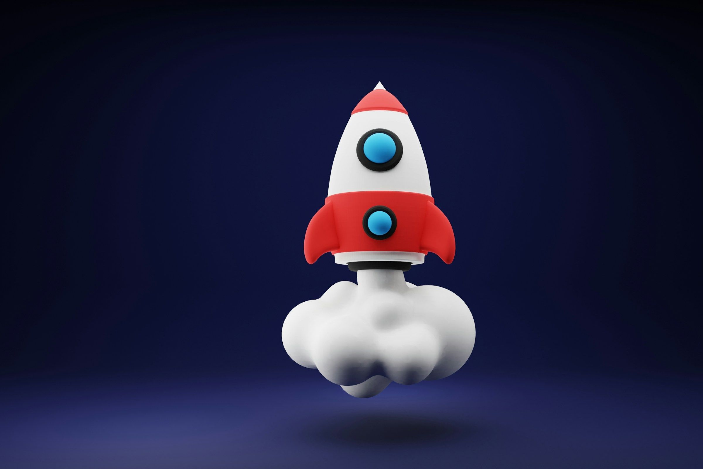 a red and white toy rocket on a blue background