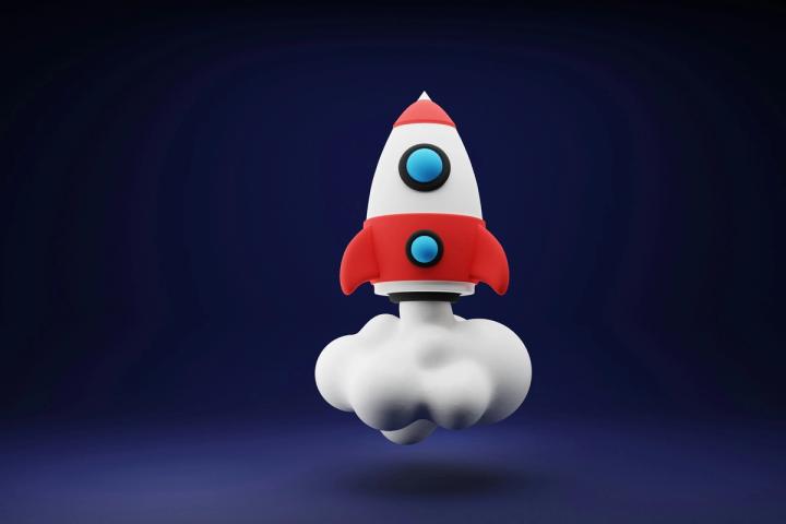 a red and white toy rocket on a blue background