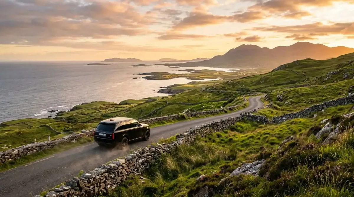 A luxury car driving on the high Upper Sky Road overlooking the Atlantic in Connemara, Ireland.