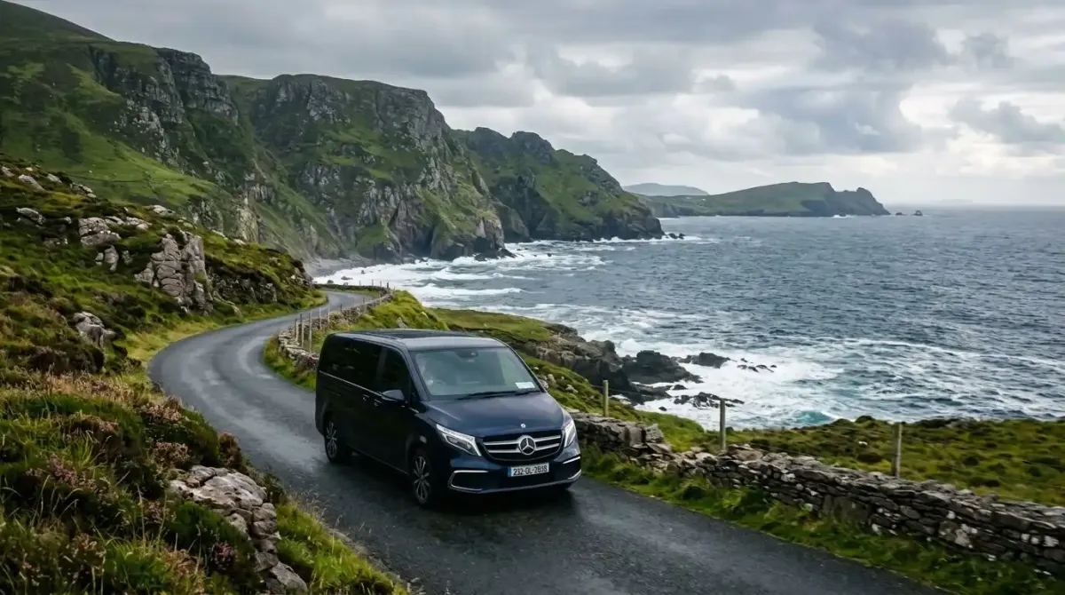 A luxury Celtic Vacations chauffeur vehicle driving along the scenic Wild Atlantic Way coastline.