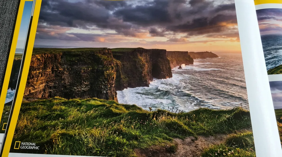 Dramatic Cliffs of Moher at golden hour with Atlantic waves crashing below