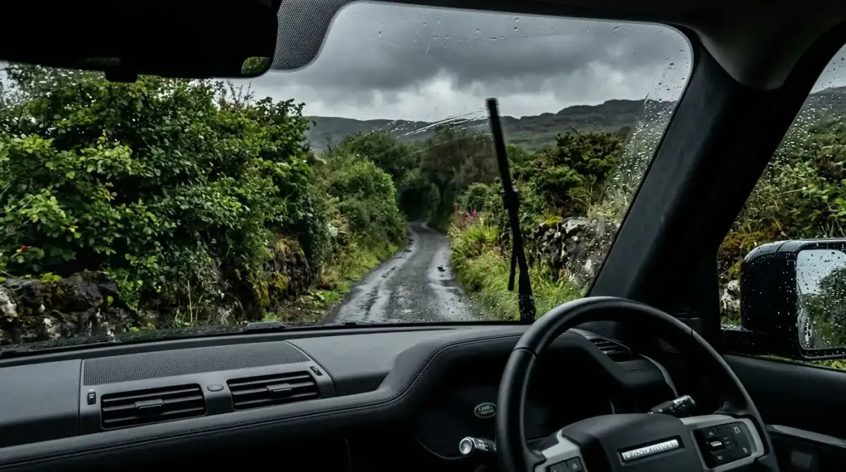 A single-lane rural Irish boreen road illustrating the physical constraints of self-driving in remote coastal counties.
