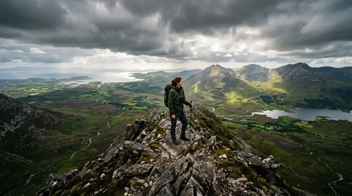 A premium hiker surveying the dramatic mountain ridges of Connemara on a luxury hiking tour in Ireland.