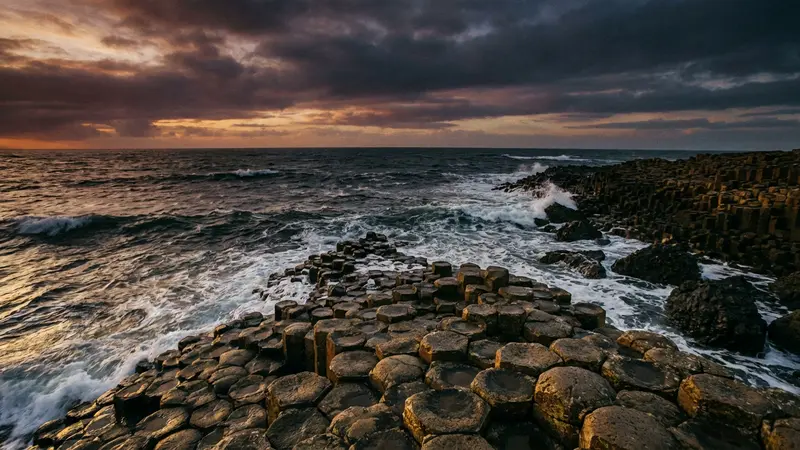Dramatic sunset over the hexagonal basalt columns of the Giant's Causeway in Northern Ireland.