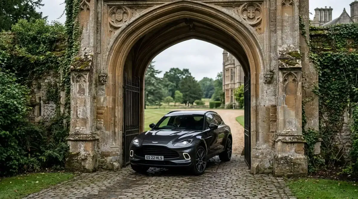 A premium automatic SUV passing through the historic gates of a luxury castle hotel package.