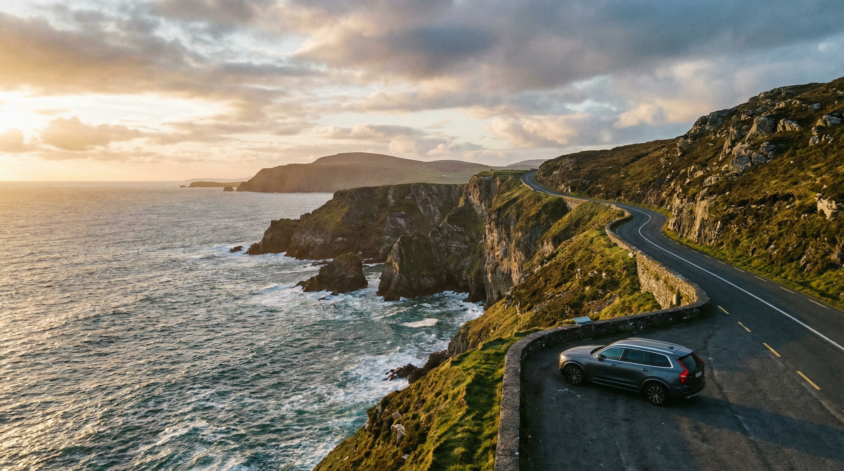 Panoramic view of the Wild Atlantic Way with dramatic cliffs and ocean at sunset, a modern rental car at a viewpoint.