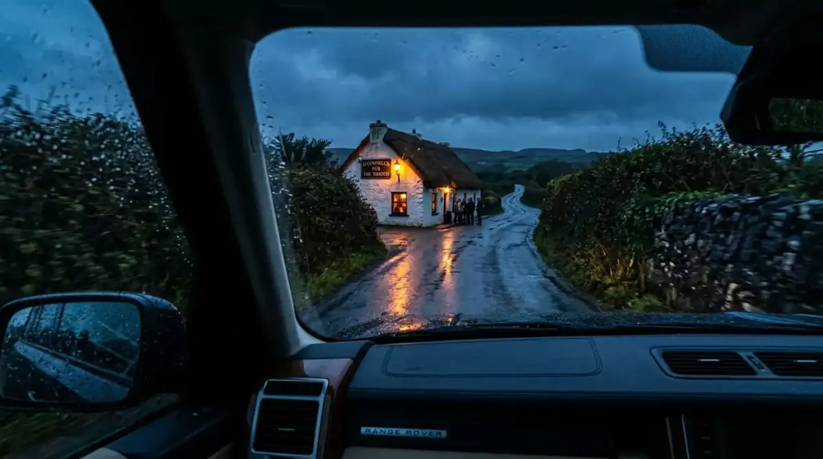 A narrow, rain-slicked rural Irish road at twilight next to a traditional village pub, highlighting local driving constraints.