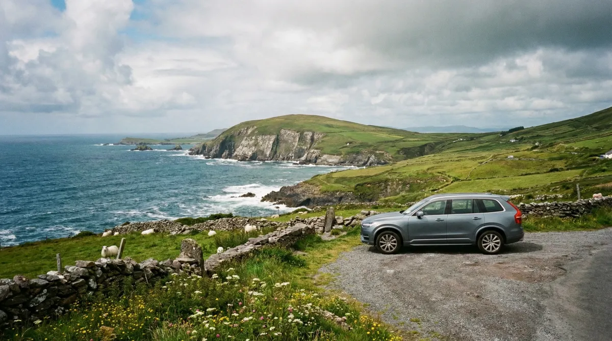 Modern rental car parked at a scenic overlook on the Ring of Kerry with dramatic coastal views.