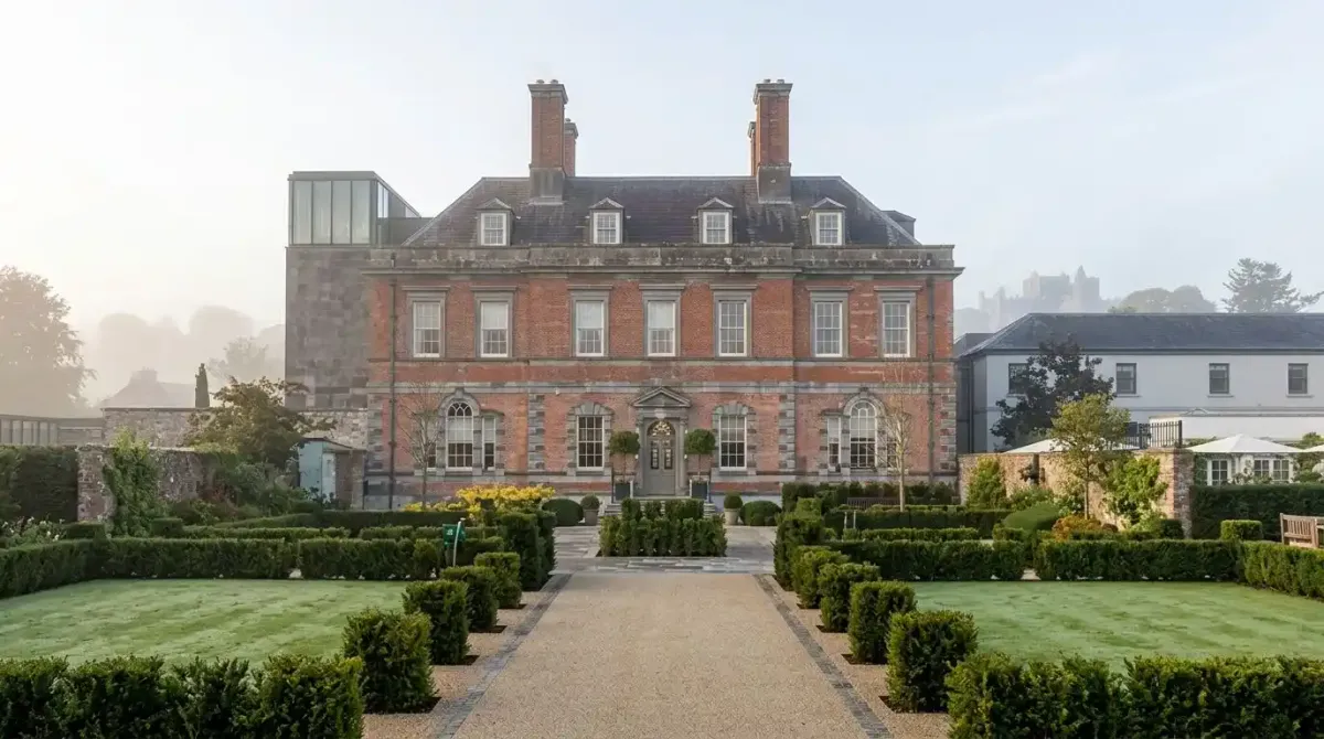 The luxury Cashel Palace Hotel with the historic Rock of Cashel in the background.