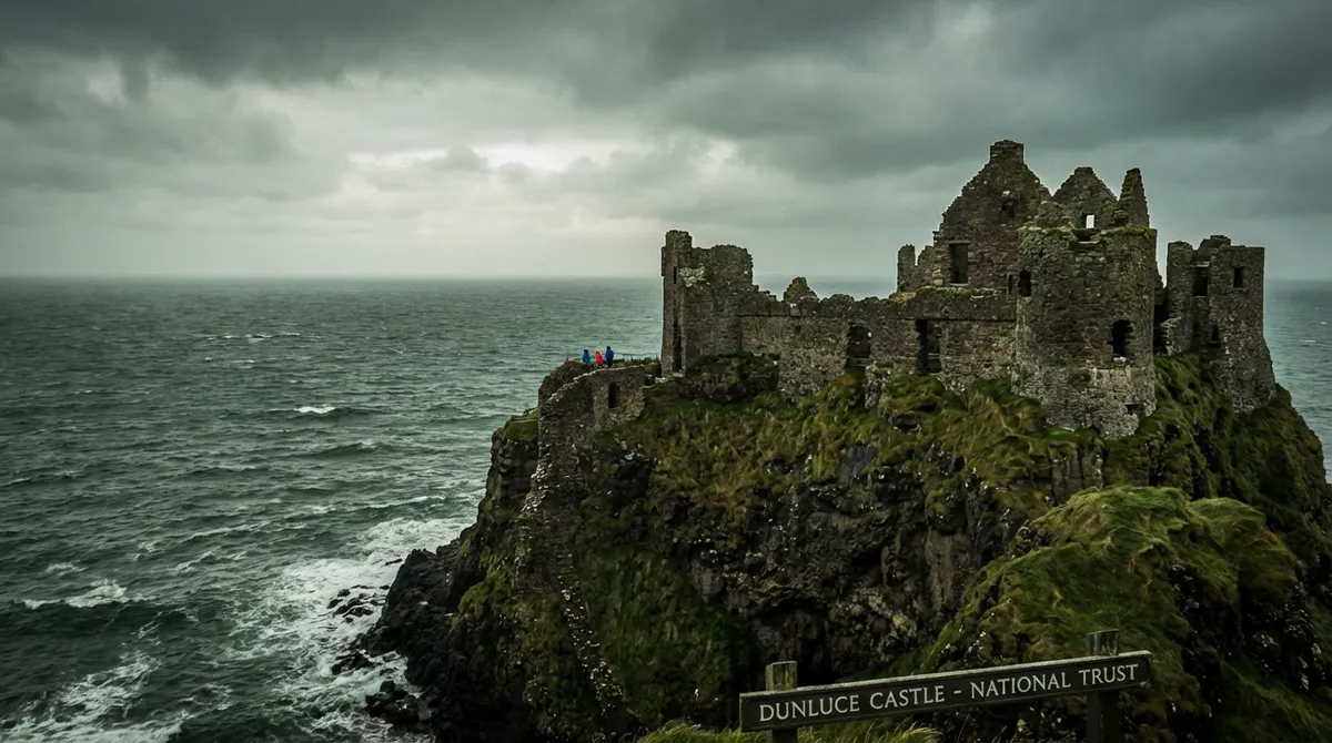 The dramatic ruins of Dunluce Castle clinging to a cliff overlooking the Atlantic Ocean.