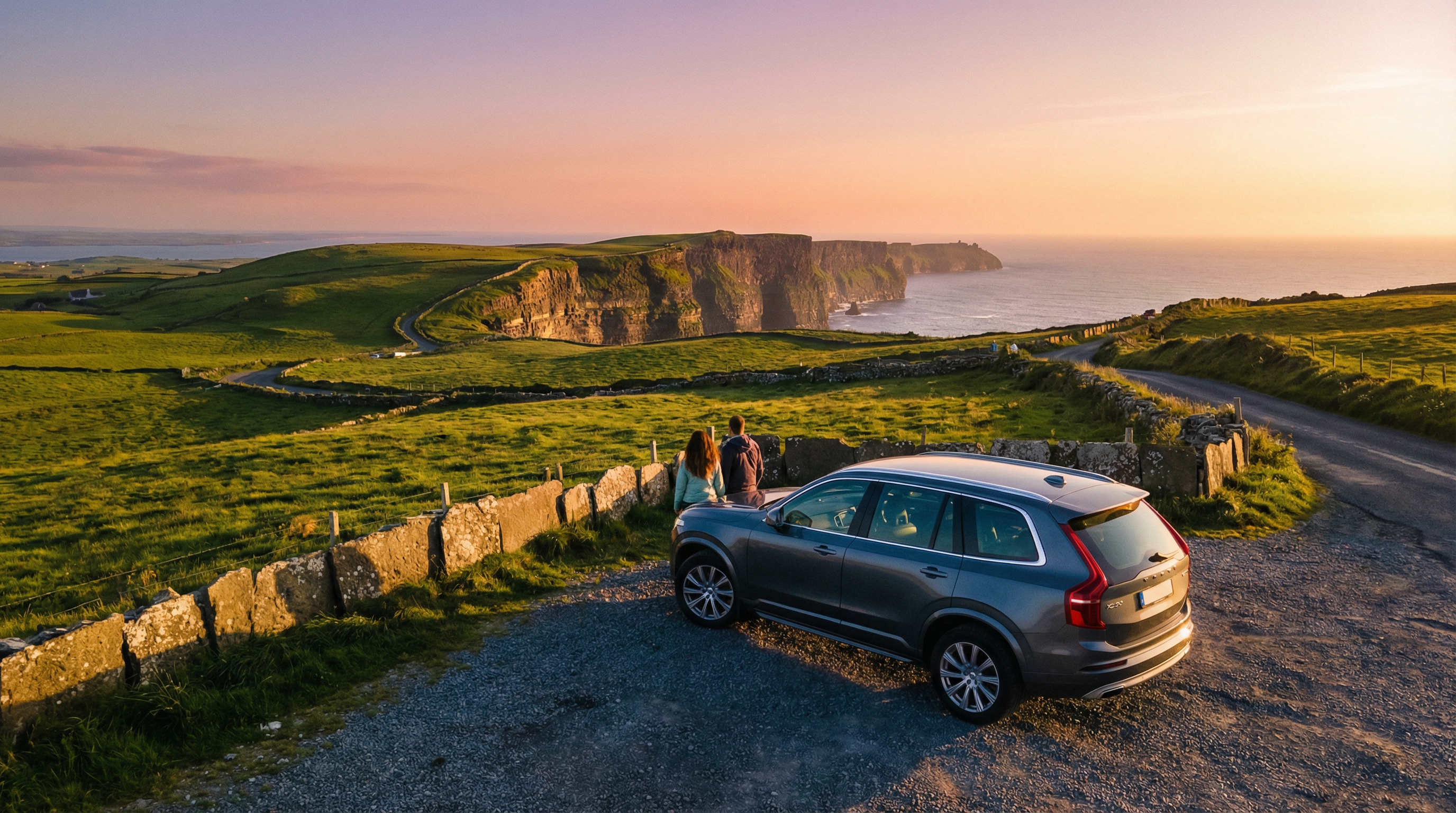 Modern rental car overlooking the dramatic Cliffs of Moher on a self-drive vacation in Ireland at sunset