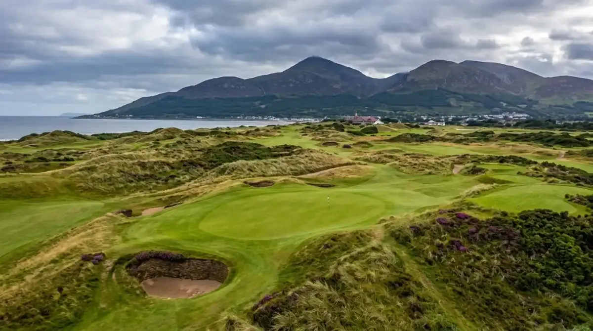 The world-class championship layout of Royal County Down links course beneath the Mourne Mountains.