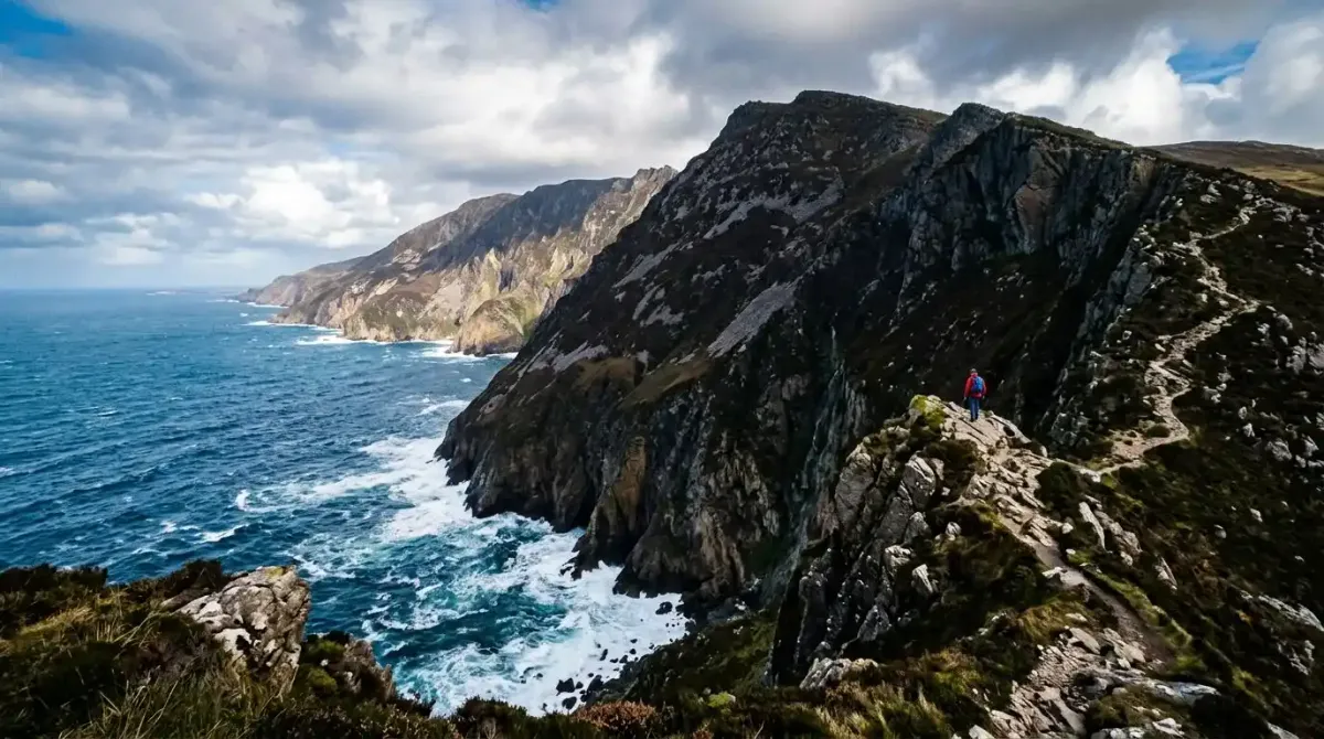 Walking the dramatic high cliff edge path of Slieve League in County Donegal on an elite Irish hiking vacation.