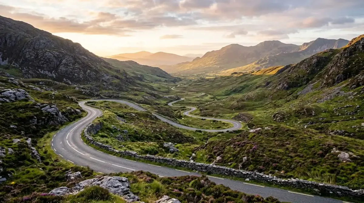 The winding scenic road through Moll's Gap in County Kerry at sunrise.
