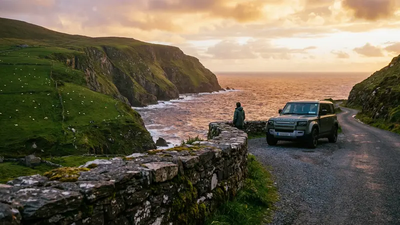 Modern SUV parked on a scenic coastal road in Ireland overlooking dramatic cliffs and the Atlantic Ocean at sunset.
