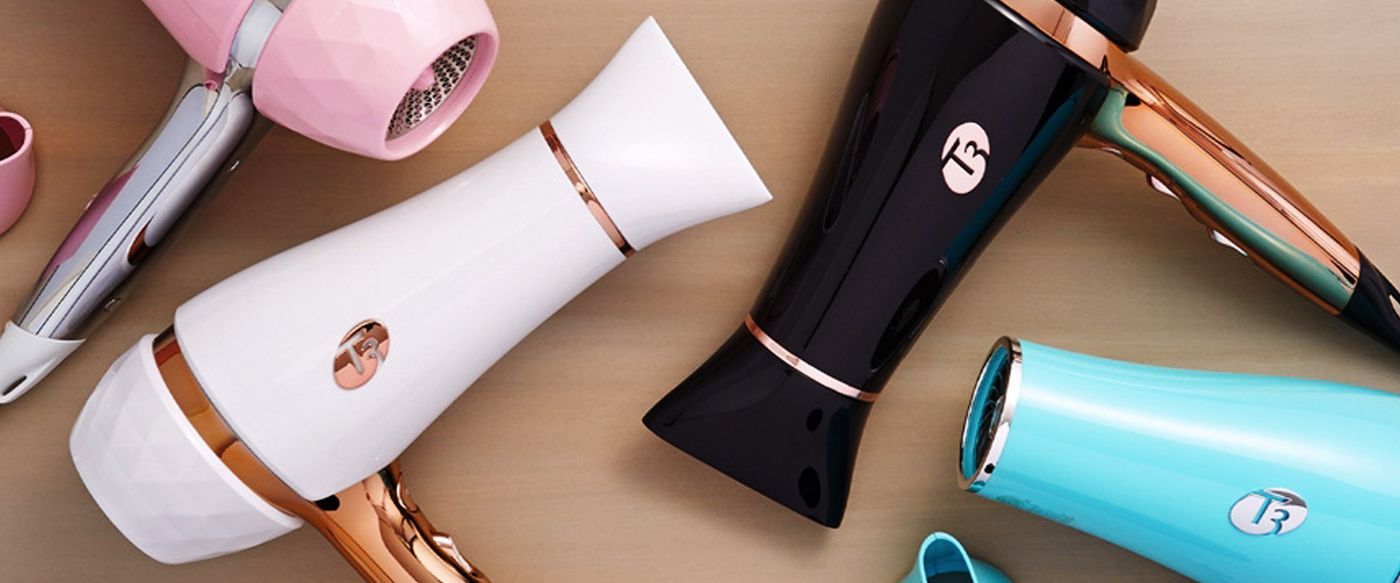 Assorted T3 hair dryers and styling tools in pink, white, black and teal finishes