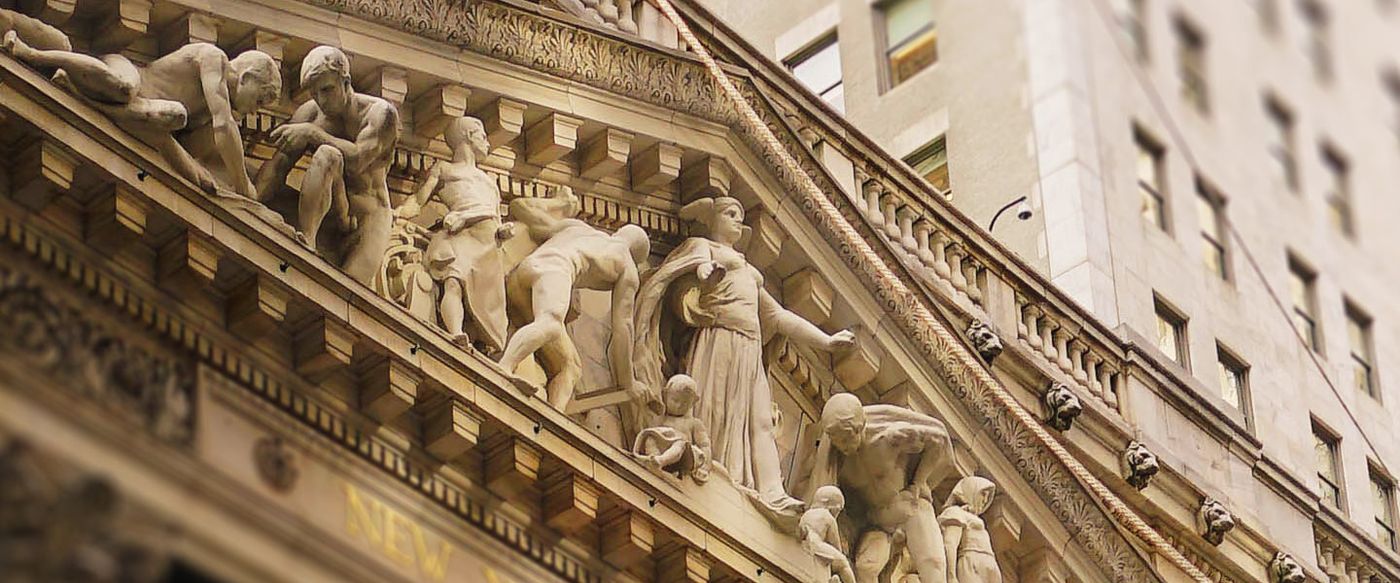 Ornate carved figures on a classical building's sculpted pediment