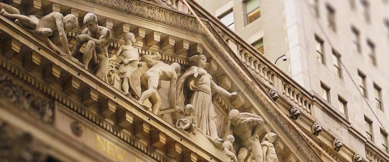 Ornate carved figures on a classical building's sculpted pediment