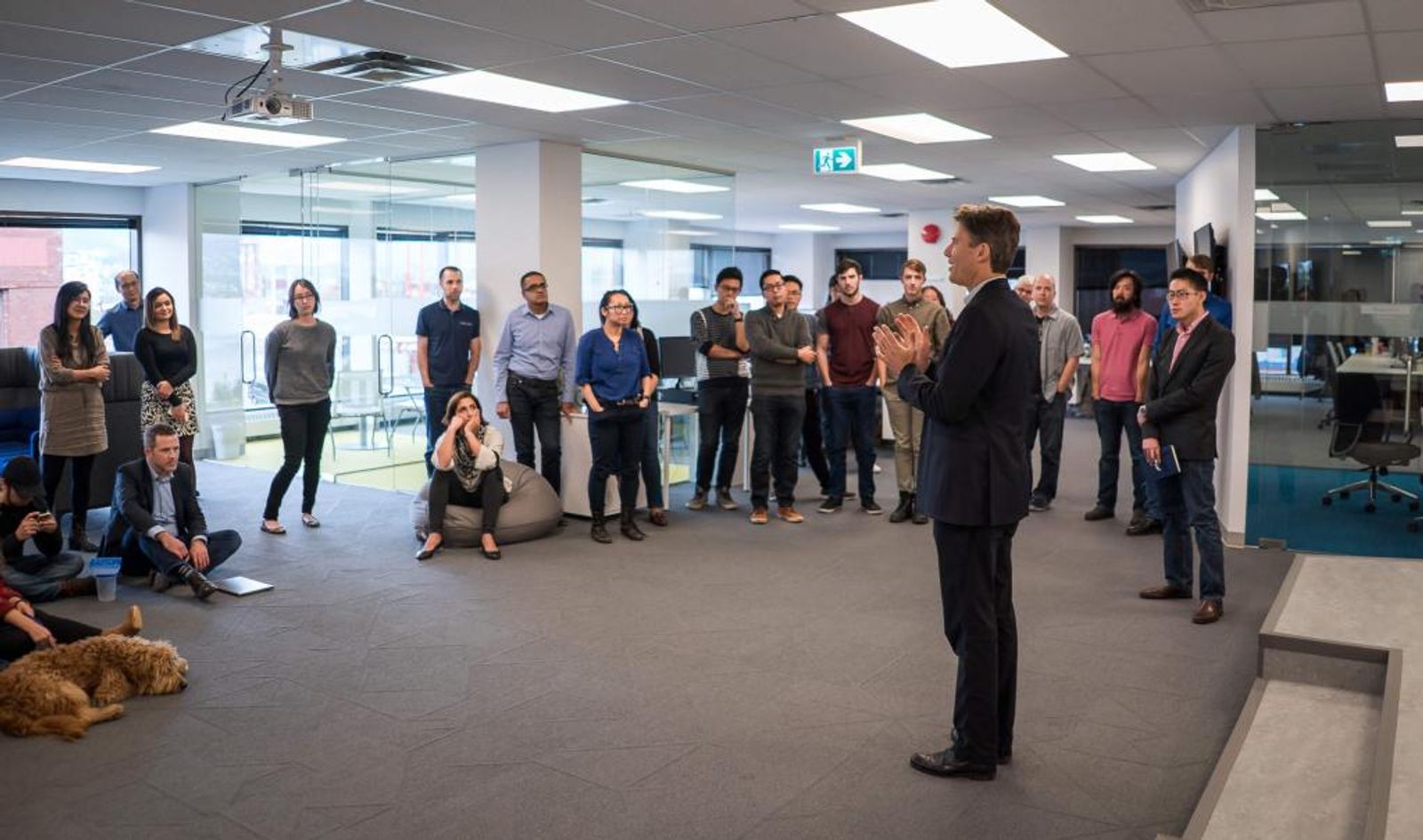 Speaker addressing Appnovation staff gathered in the office