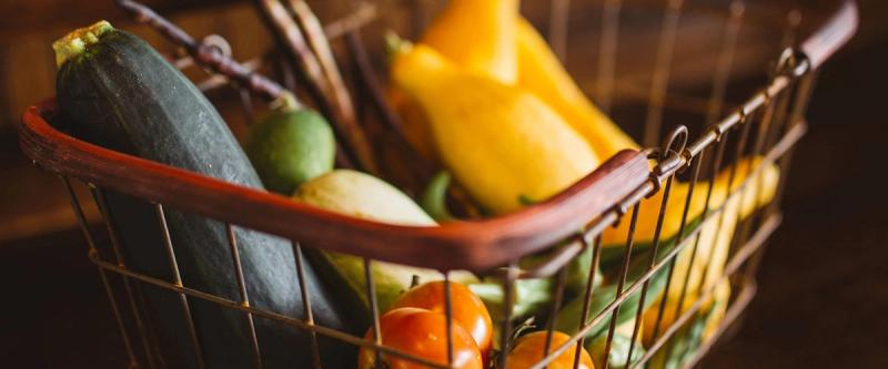 Wire shopping basket filled with fresh vegetables