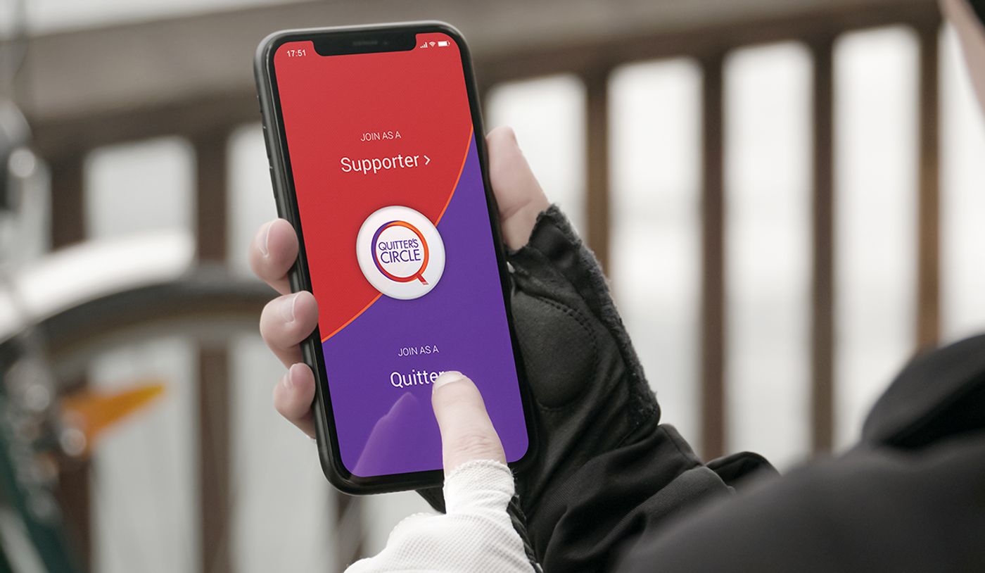 A phone displaying the Quitters' Circle app's join-as-supporter or join-as-quitter screen