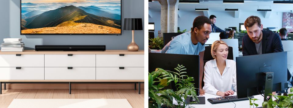 TV mounted above a console beside a team working together at office monitors