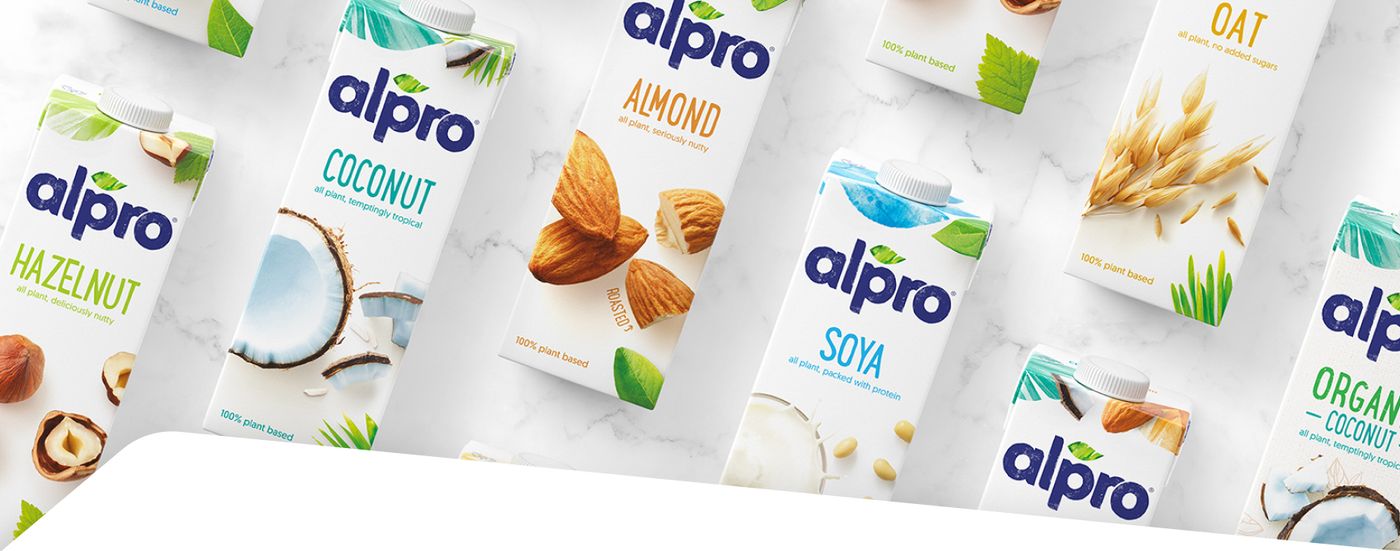 Alpro plant-based milk cartons in hazelnut, coconut, almond, oat and soya varieties displayed together