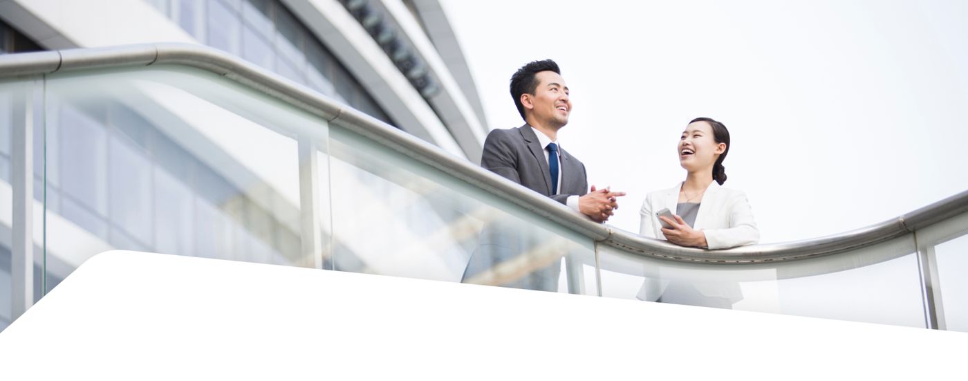 Two colleagues chatting on an office balcony
